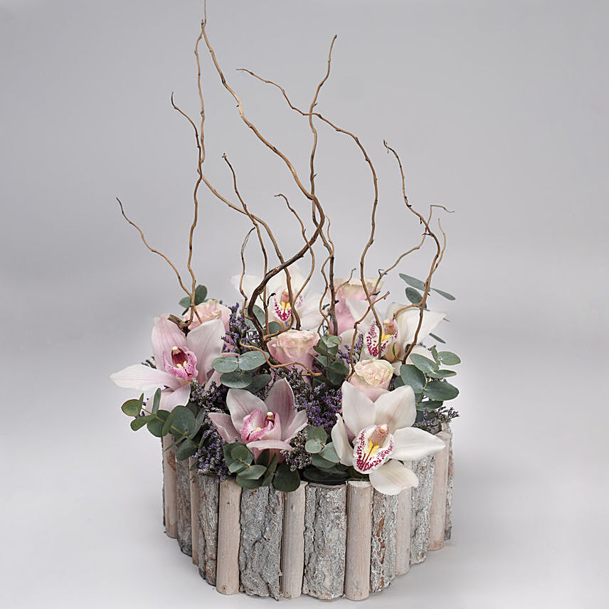 Cheerful Mixed Flowers Wooden Pot: Send Anniversary Gifts To Qatar