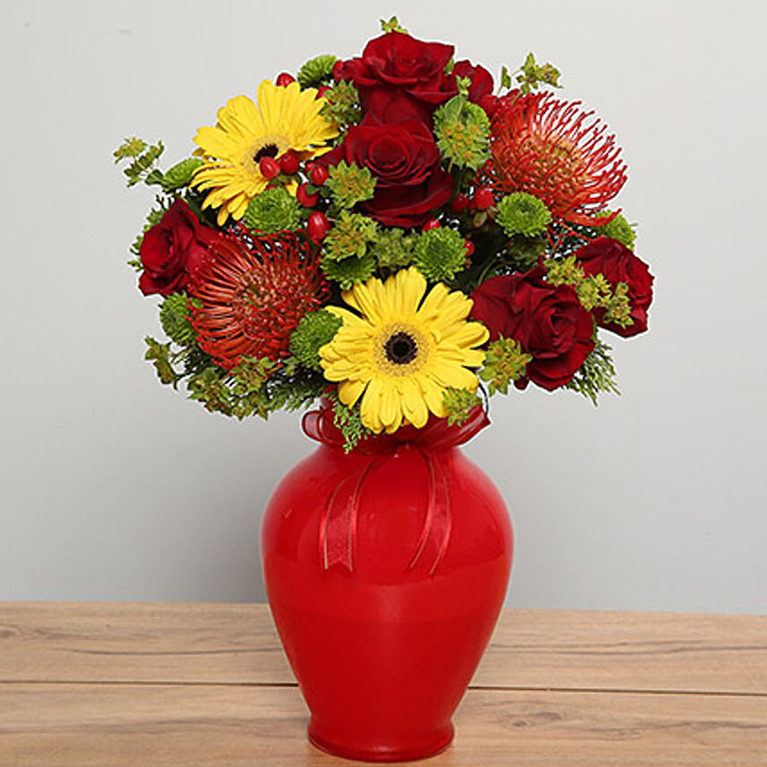Mixed Flowers Arrangement In Red Glass Vase