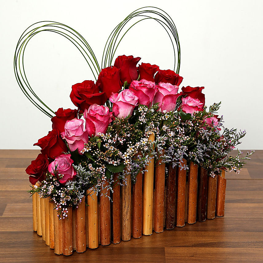 Red and Purple Roses In A Wooden Base