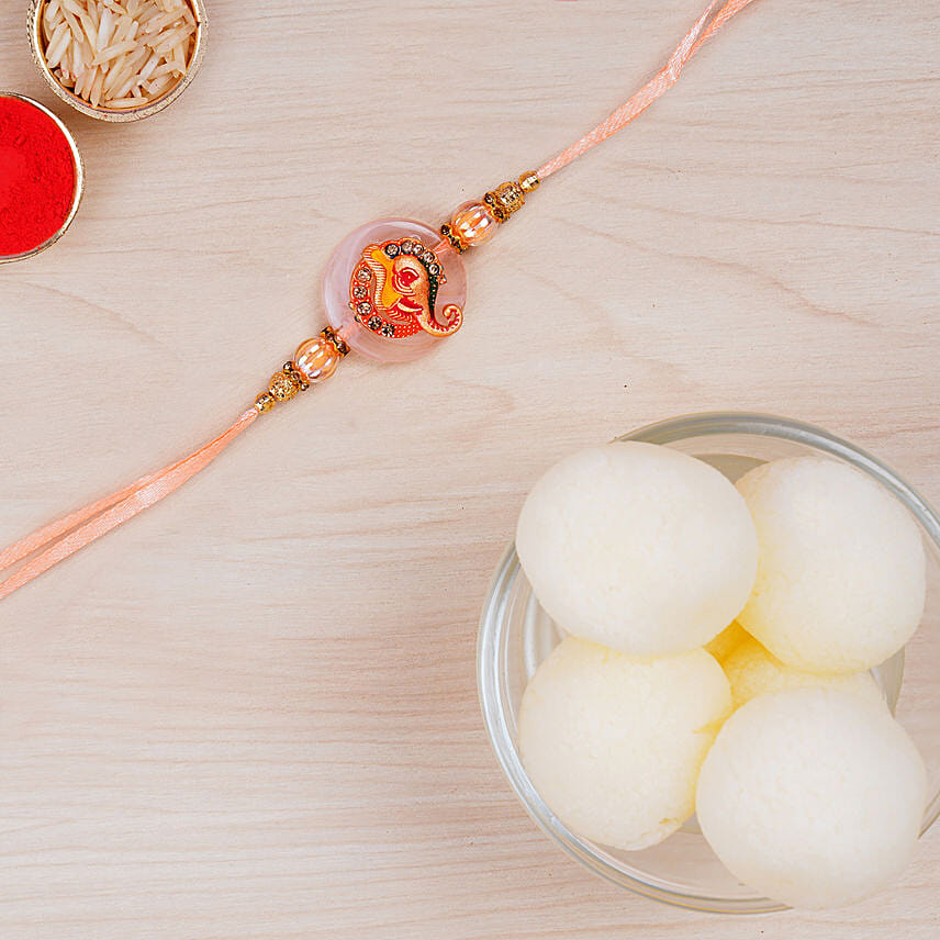 Ganesha Rakhi And Haldiram Rasgulla Tin Combo