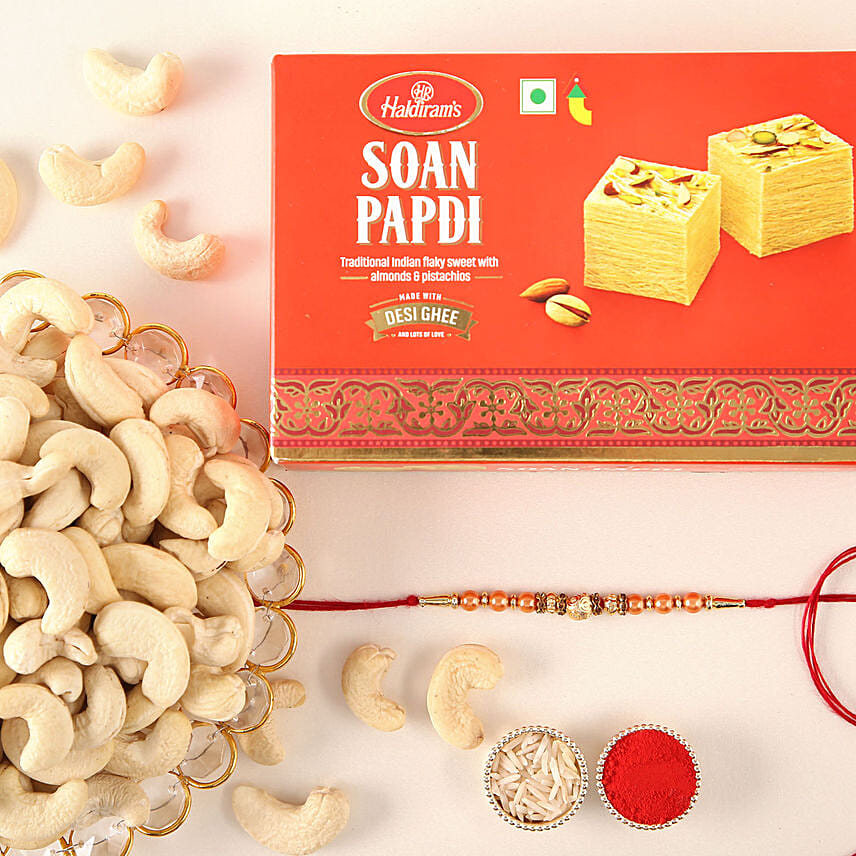 Rose Gold Pearl And Beads Rakhi with 250 Grams Soan Papdi and Cashew