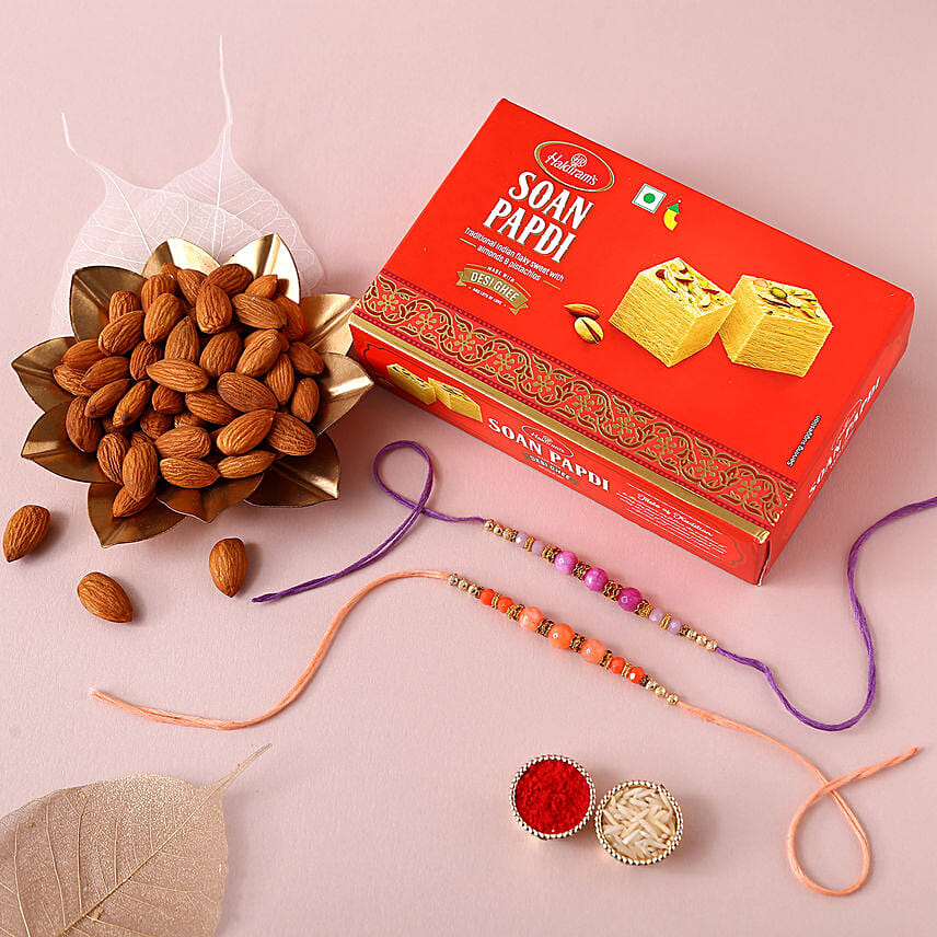 Sneh Peachy Rakhi Set with 250 Grams Soan Papdi and Almonds