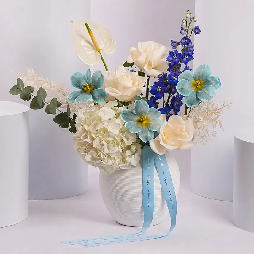 Elegant Blue and White Flower Arrangement in Ceramic Vase