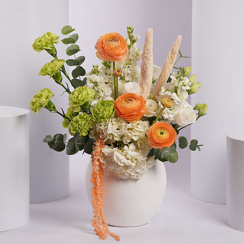 Vibrant Orange and Green Flower Arrangement in White Vase