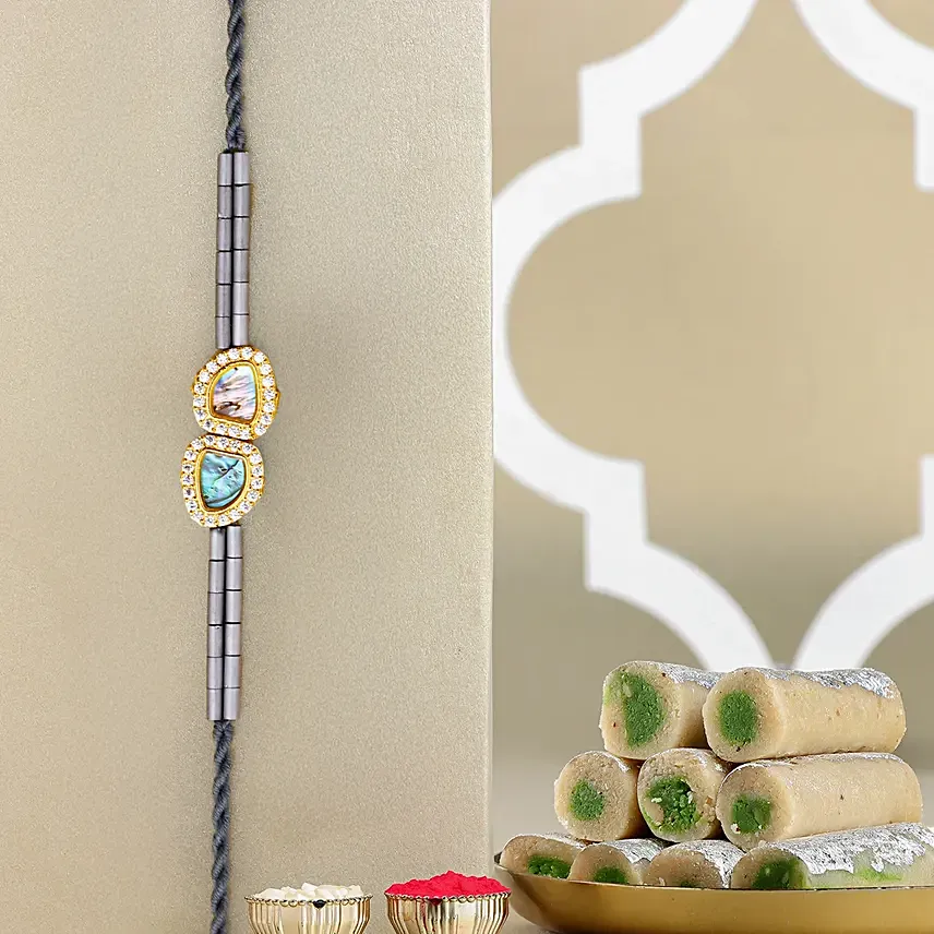 Regal Crest Beads Rakhiand Kaju Roll: Rakhi with Sweets