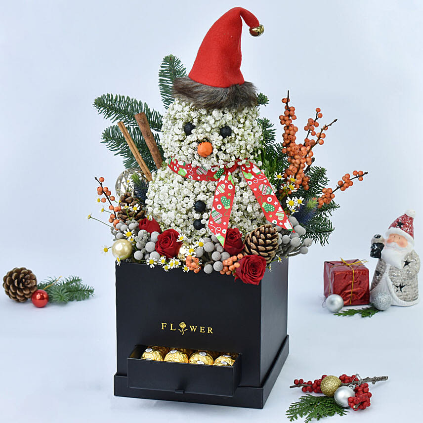 ورد على شكل رجل ثلج في صندوق أسود وشوكولاتة فيريرو روشيه ورد على شكل رجل ثلج في صندوق أسود وشوكولاتة فيريرو روشيه: أرسل زهور عيد الميلاد إلى عجمان