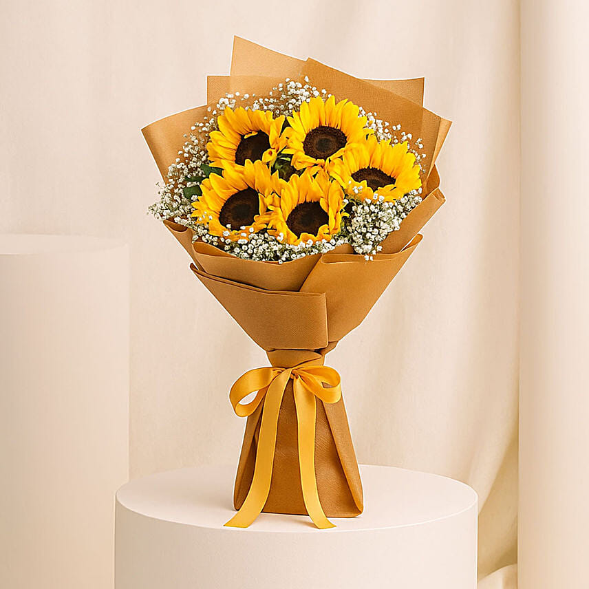 باقة ورد عباد الشمس الصفراء مع جيبسوفيلا في غلاف: أرسل هدايا عيد الميلاد إلى قطر