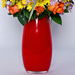 Enticing Mixed Flowers In Red Designer Vase