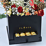 ورد على شكل رجل ثلج في صندوق أسود وشوكولاتة فيريرو روشيه